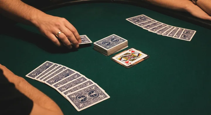 The deal in Oklahoma Gin: cards dealt to each player beside the stock and discard pile